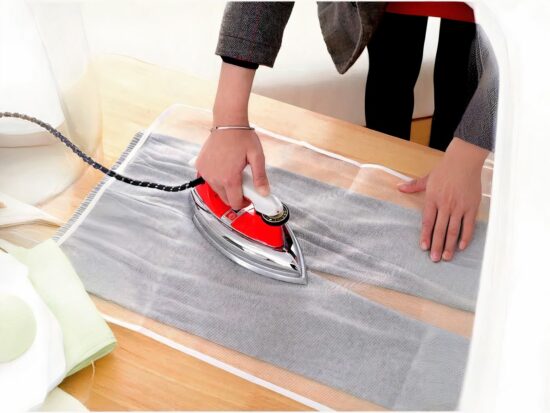 tapis de repassage avec une femme qui tient un fer à repassé sur une table en bois