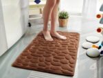 Tapis de salle de bain moelleux en forme de galets. Bonne qualité, confortable, pour salle de bain. Couleur marron